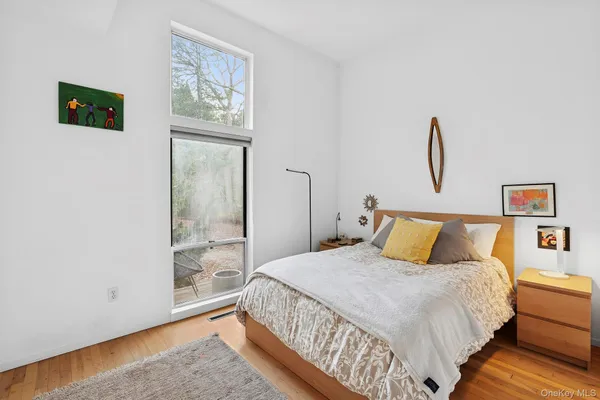 a bed sitting in a bedroom next to a window