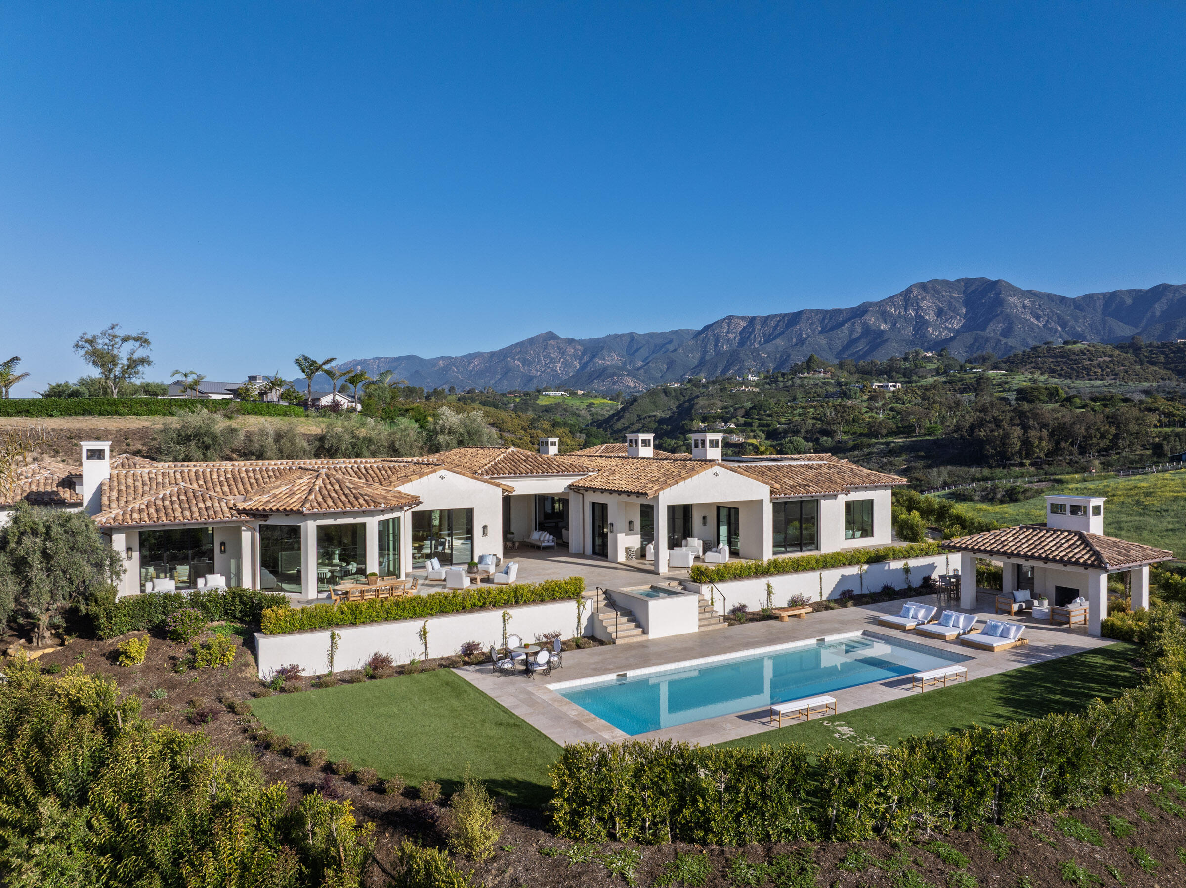 an aerial view of a house with swimming pool garden view and a lake view