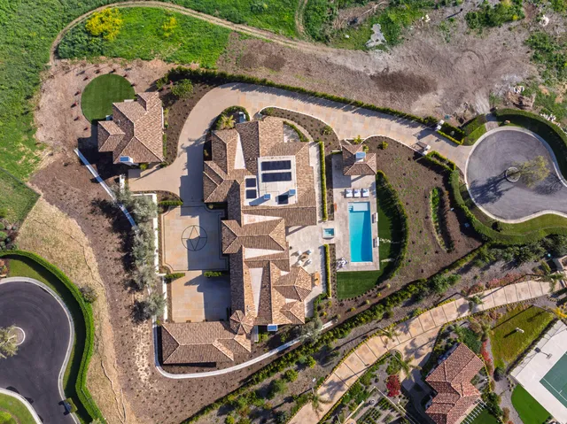 an aerial view of a house with a swimming pool