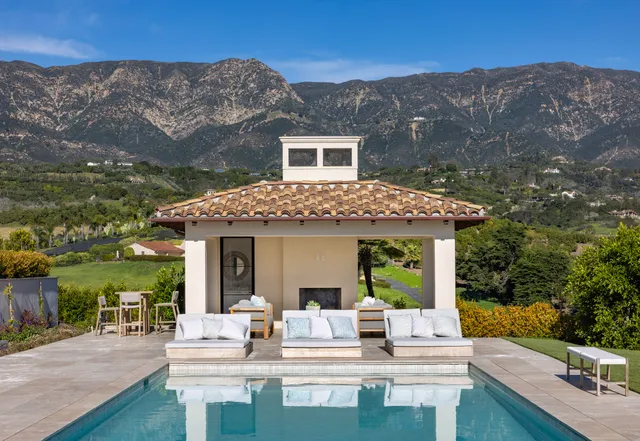 a view of house with a backyard and patio