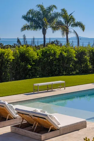 a view of a tennis court with palm trees