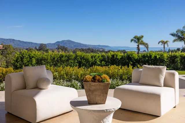 a view of a patio with couches table and chairs