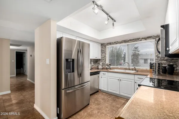a view of a bedroom with window and ceiling fan