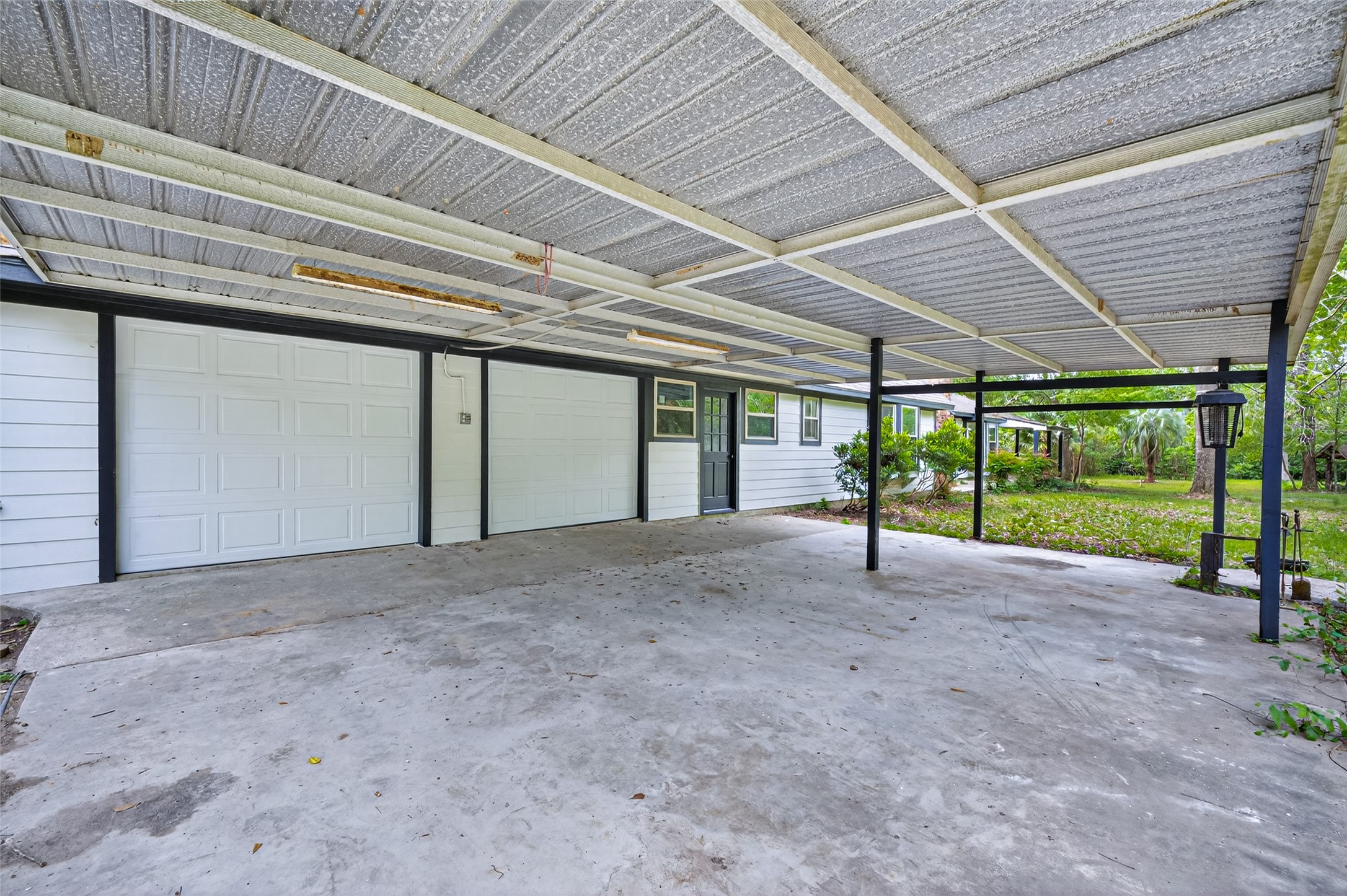 23607 Cardinal Drive Hockley, TX 77447 - Photo 42 of 50 An attached carport provides additional covered protection, ideal for larger vehicles or maintaining a shaded outdoor workspace.