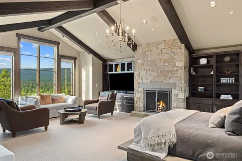 a spacious bedroom with a large bed and a fireplace