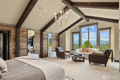 a bedroom with furniture large window and a bathtub