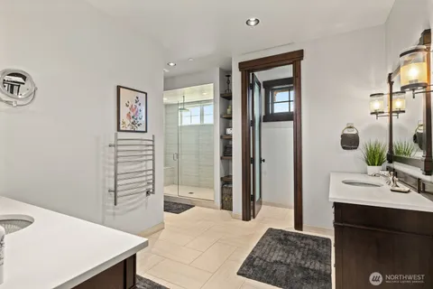 a spacious bathroom with a granite countertop sink a mirror and shower