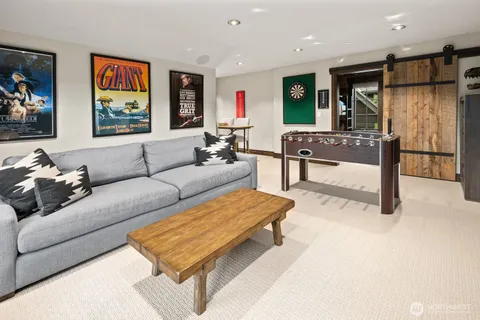 a living room with furniture a window and a wall painting