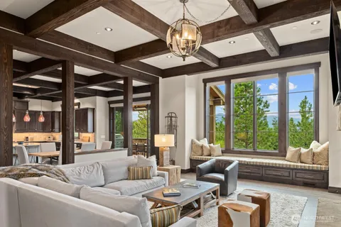 a living room with furniture and floor to ceiling windows