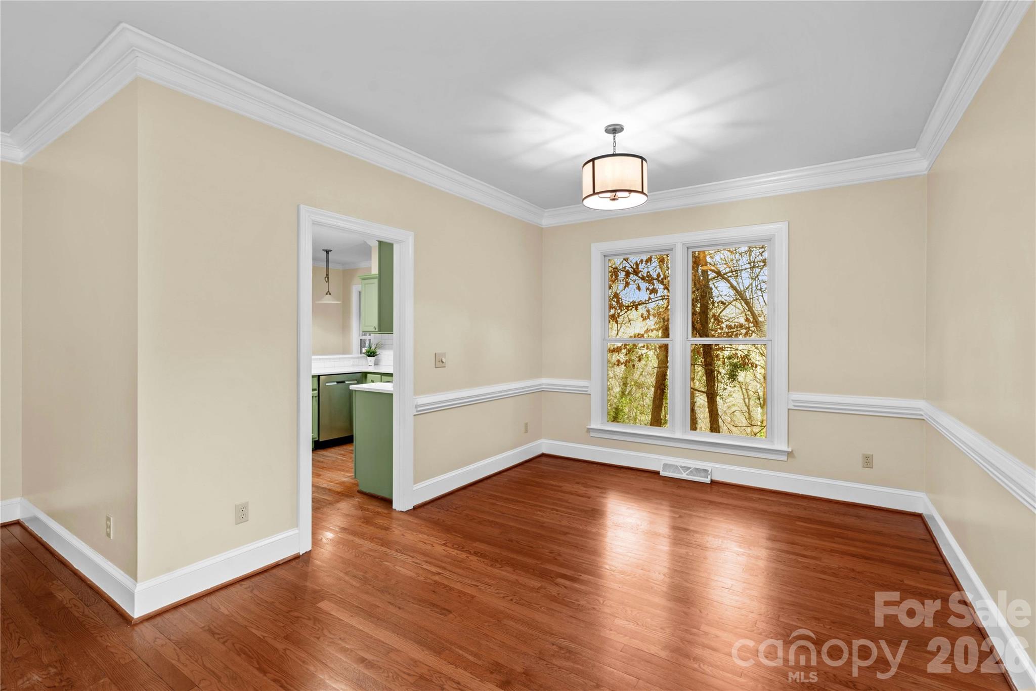 131 Morrison Hill Road Davidson, NC 28036 - Photo 15 of 47 an empty room with wooden floor chandelier and windows