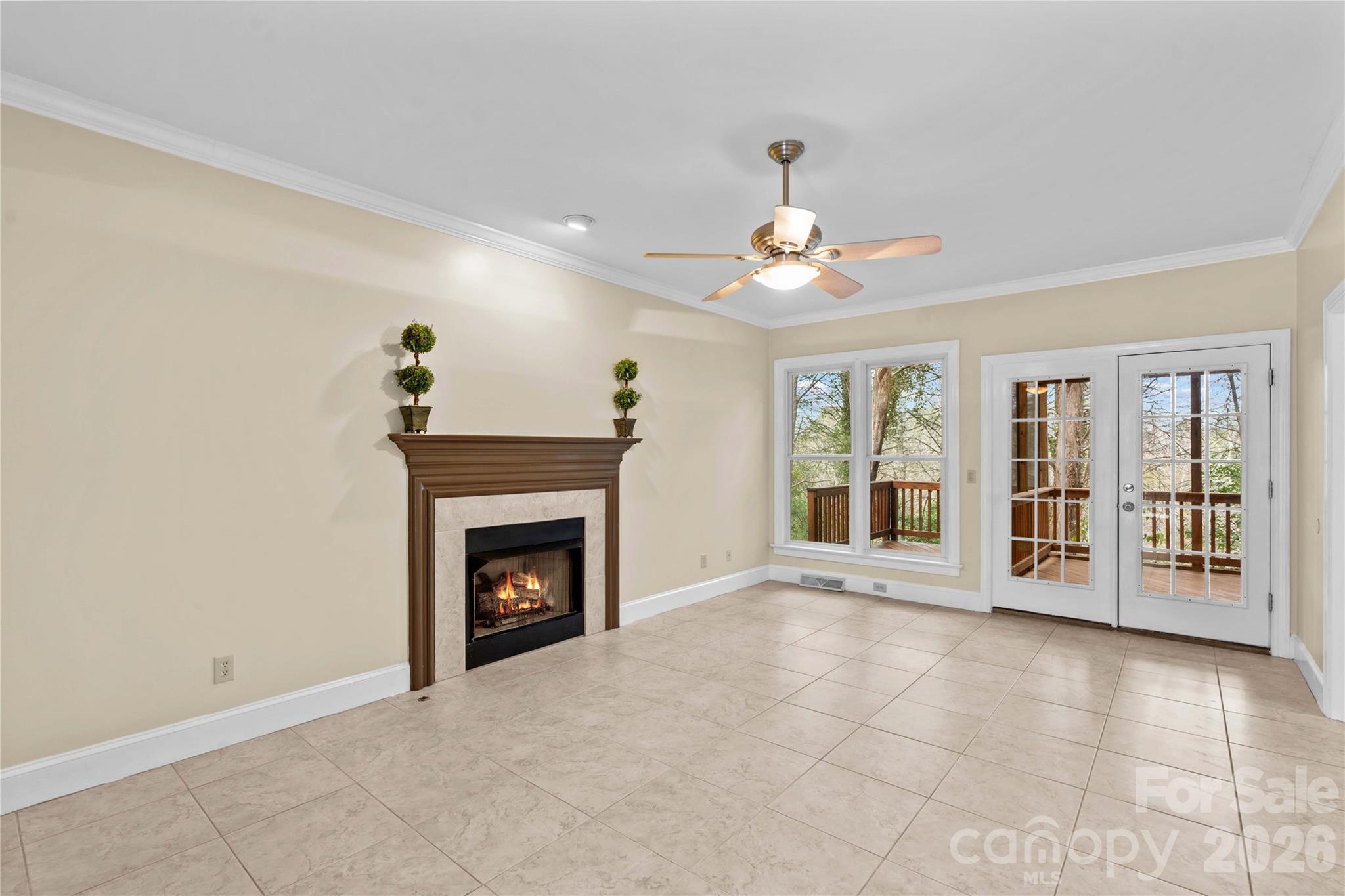 131 Morrison Hill Road Davidson, NC 28036 - Photo 10 of 47 a view of an empty room with a fireplace and a window