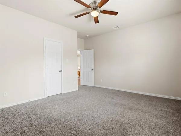 an empty room with closet and windows