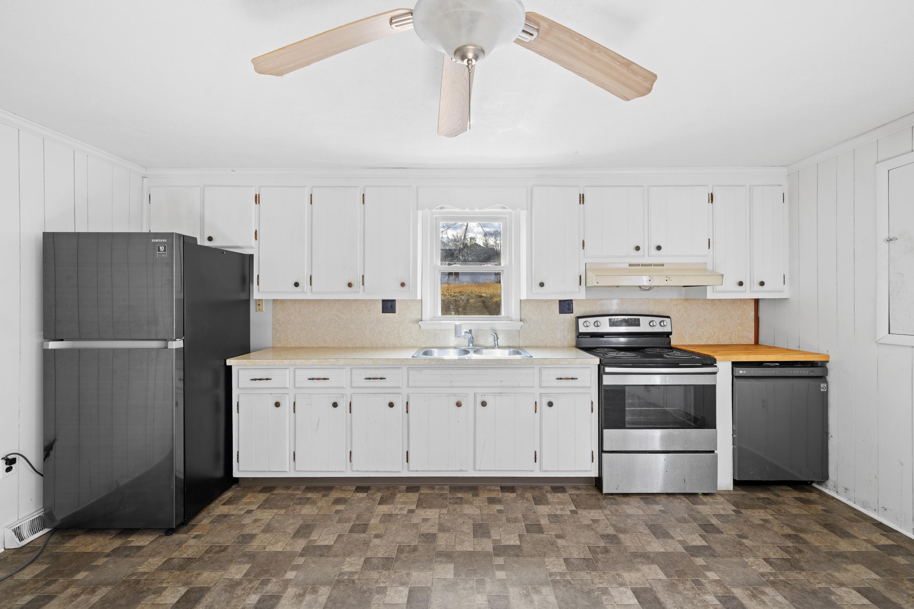 1340 B Street Waynesboro, VA 22980 - Photo 11 of 52 a kitchen with granite countertop a refrigerator stove top oven and cabinets