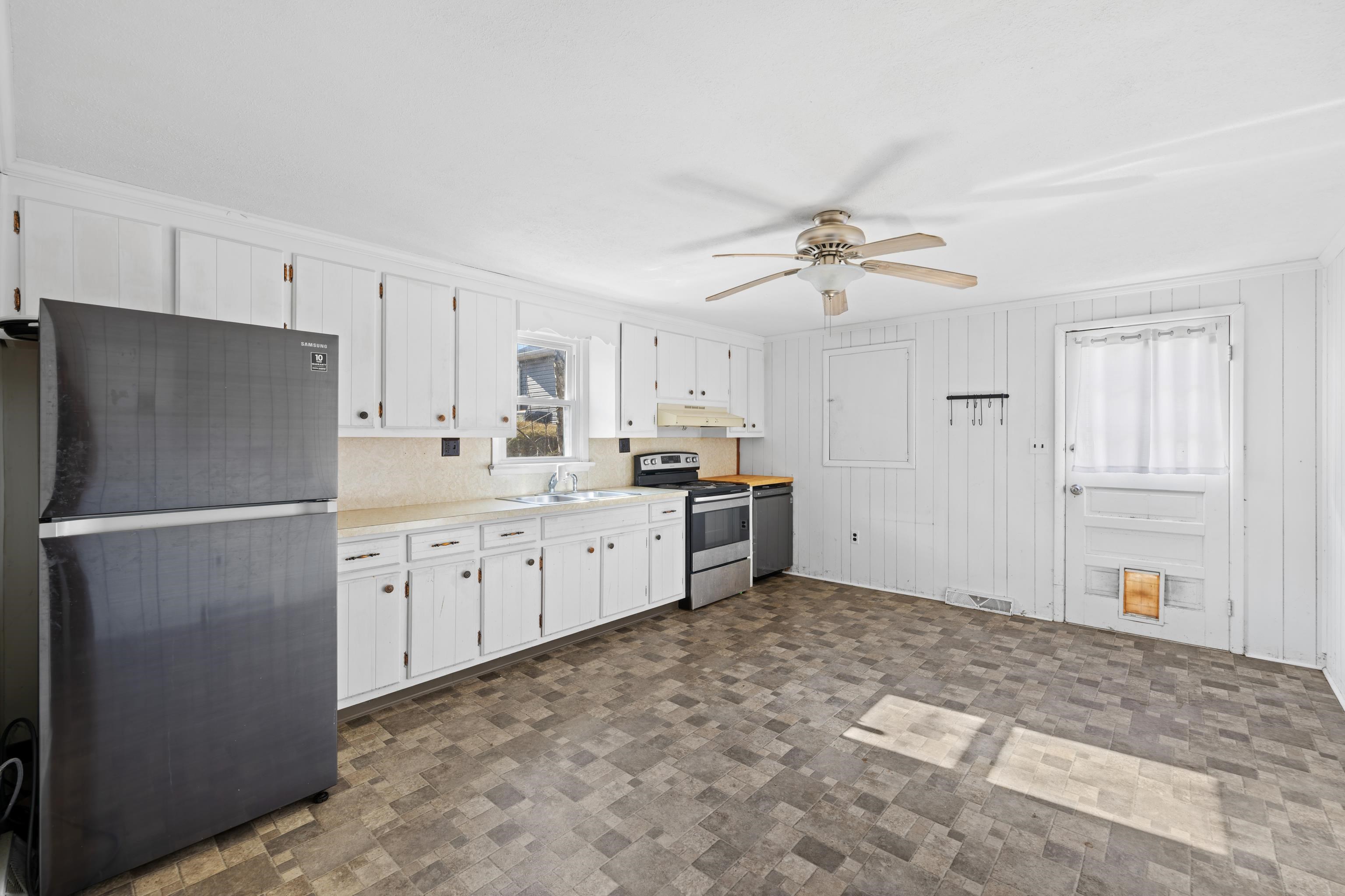 1340 B Street Waynesboro, VA 22980 - Photo 9 of 52 a kitchen with cabinets a refrigerator and a sink