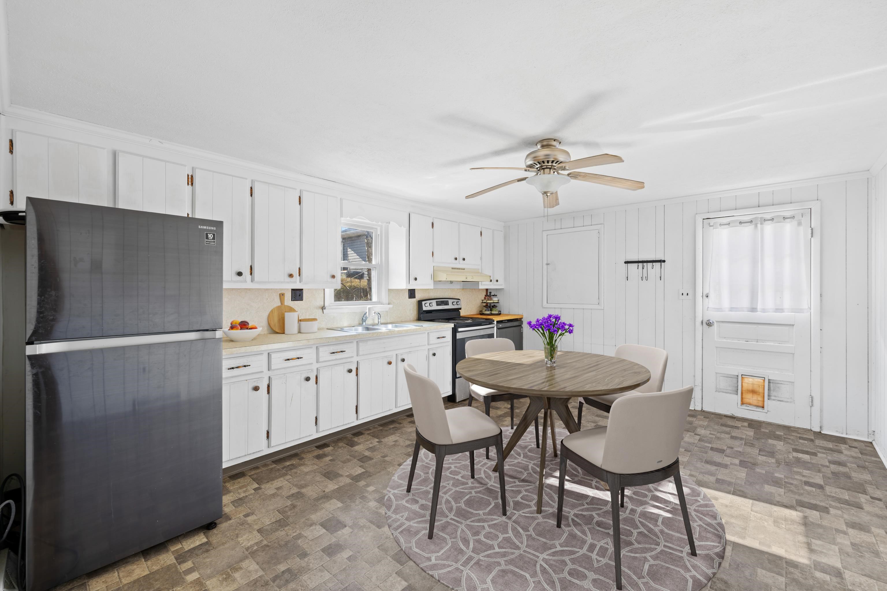1340 B Street Waynesboro, VA 22980 - Photo 10 of 52 a kitchen with stainless steel appliances a table chairs and a refrigerator