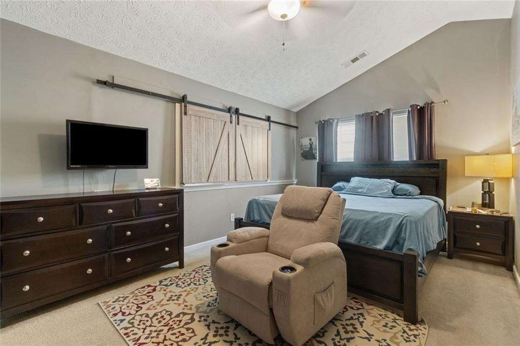 163 Silver Fox Trail Dallas, GA 30157 - Photo 12 of 35 a bedroom with a bed and flat screen tv