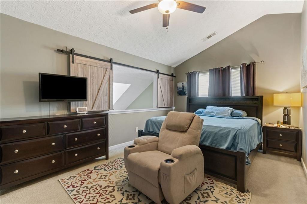 163 Silver Fox Trail Dallas, GA 30157 - Photo 13 of 35 a bedroom with a bed and a flat screen tv