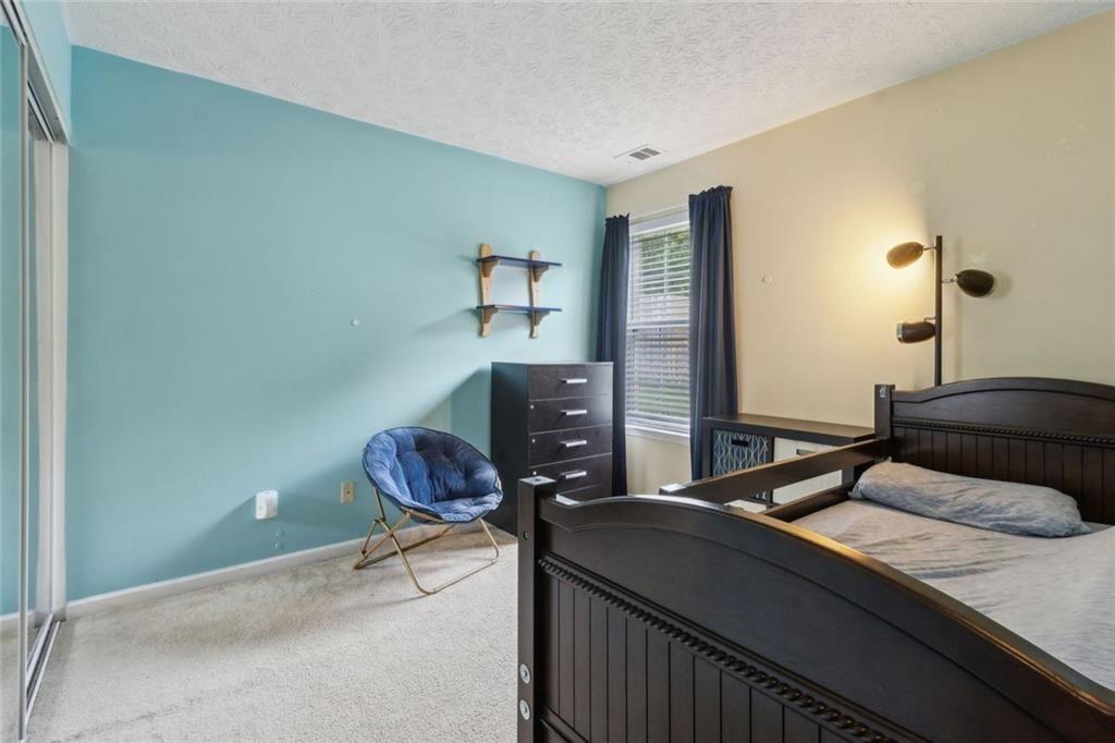 163 Silver Fox Trail Dallas, GA 30157 - Photo 18 of 35 a bedroom with a bed and window