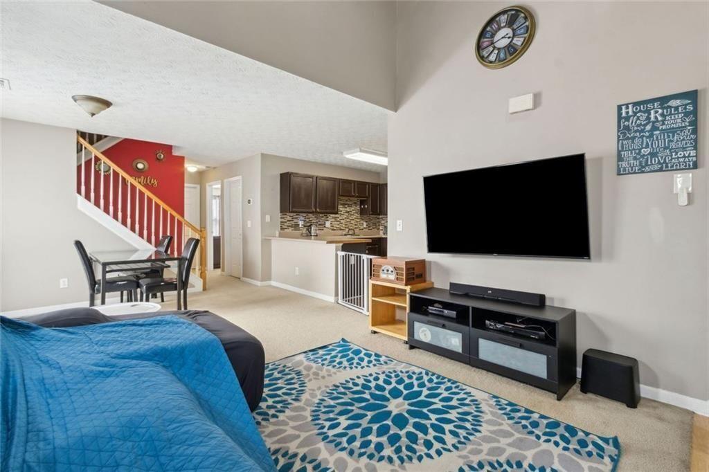 163 Silver Fox Trail Dallas, GA 30157 - Photo 2 of 35 a living room with furniture and a flat screen tv