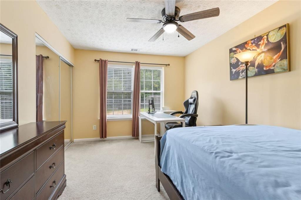 163 Silver Fox Trail Dallas, GA 30157 - Photo 22 of 35 a bed room with a bed and a television