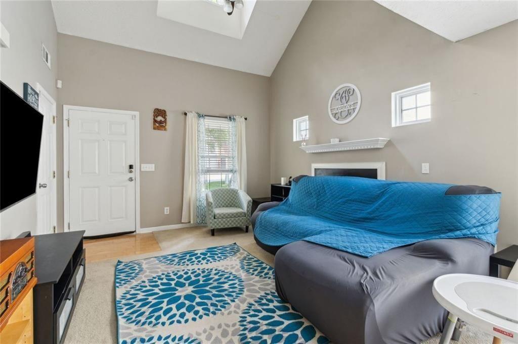 163 Silver Fox Trail Dallas, GA 30157 - Photo 4 of 35 a living room with a couch and a flat screen tv