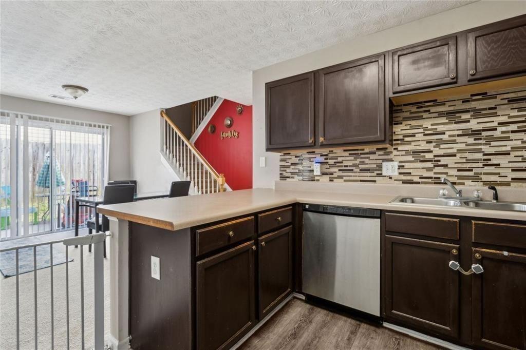 163 Silver Fox Trail Dallas, GA 30157 - Photo 10 of 35 a kitchen with stainless steel appliances granite countertop a sink and a microwave