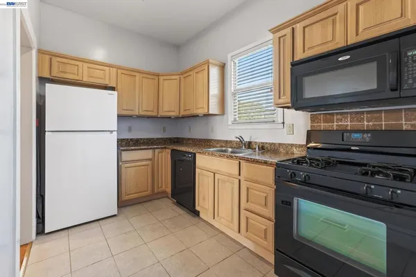 a kitchen with a stove microwave and cabinets