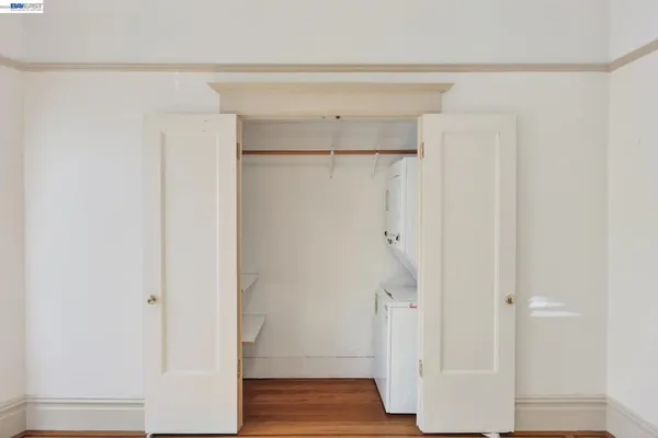 a view of walk in closet with wooden floor