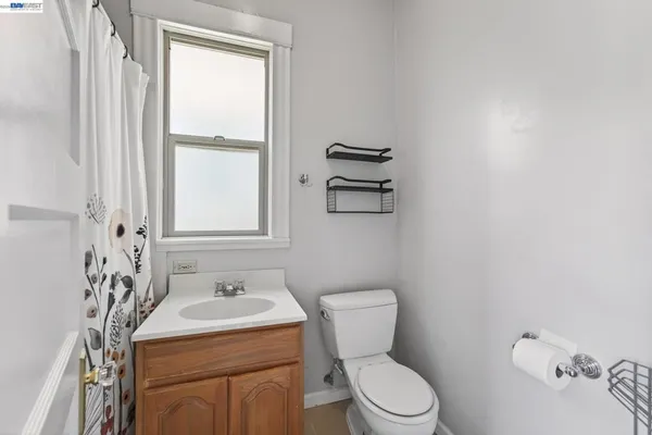 a bathroom with a sink a toilet and a window