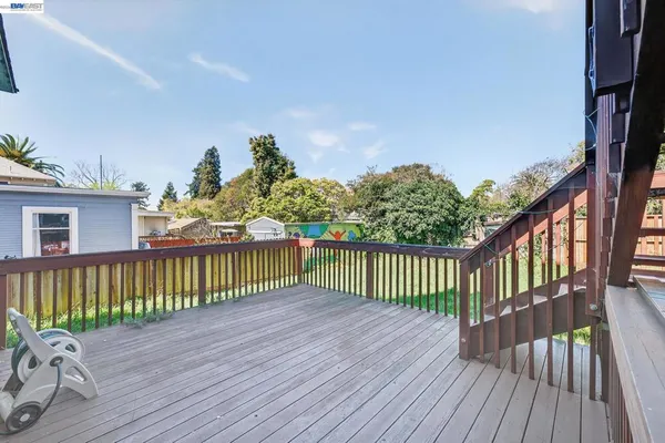 a balcony with wooden floor in front of it