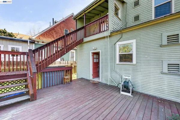 a view of backyard with deck and wooden floor