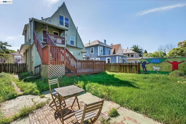 a view of a house with a yard and potted plants