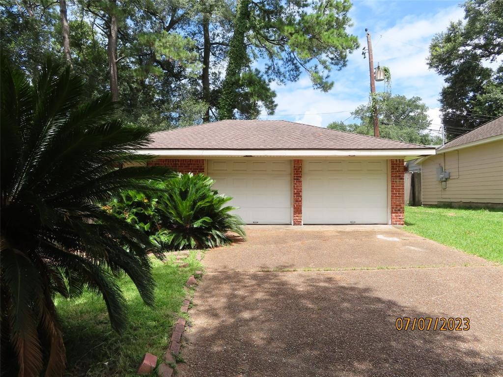 403 High Ridge Street Houston, TX 77013 - Photo 2 of 13 a front view of a house with a yard and a garage