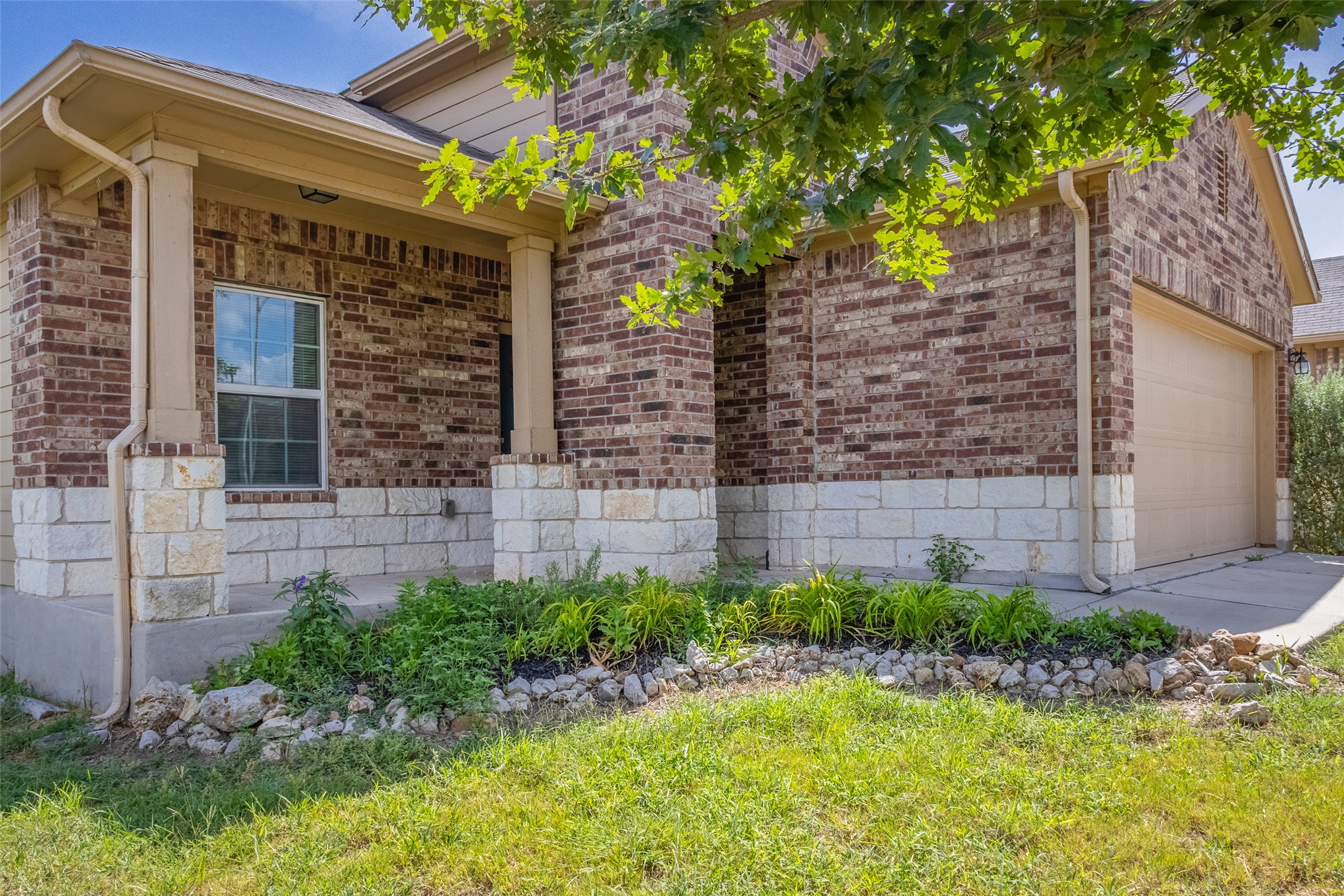 7225 Ranchito Drive Austin, TX 78744 - Photo 3 of 39 A classic brick exterior with a welcoming porch and mature landscaping.
