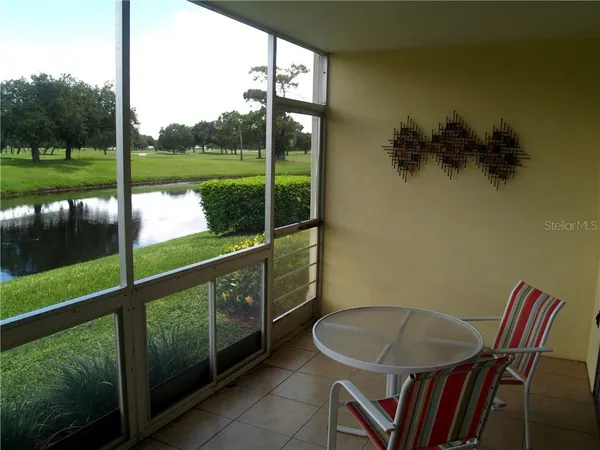 a view of a porch with chairs and backyard