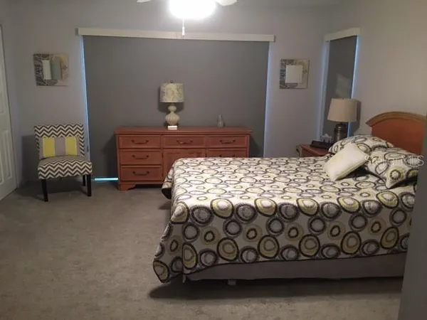a bedroom with a bed and a lamp