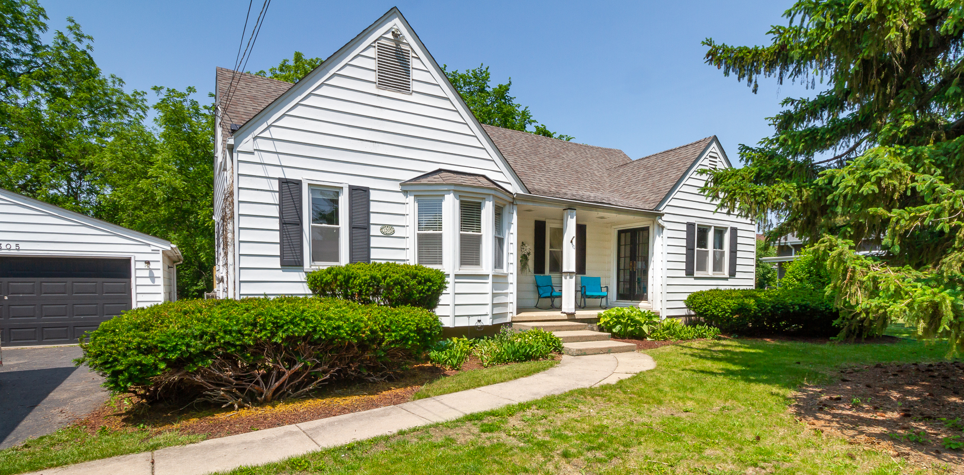 1305 Daly Road Wheaton, IL 60187 - Photo 1 of 27 a front view of a house with garden