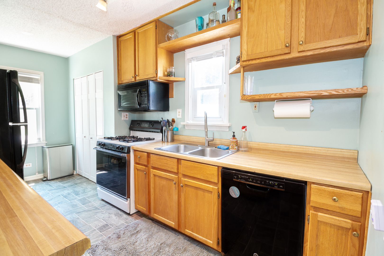 1305 Daly Road Wheaton, IL 60187 - Photo 8 of 27 a kitchen with stainless steel appliances granite countertop a sink stove and refrigerator