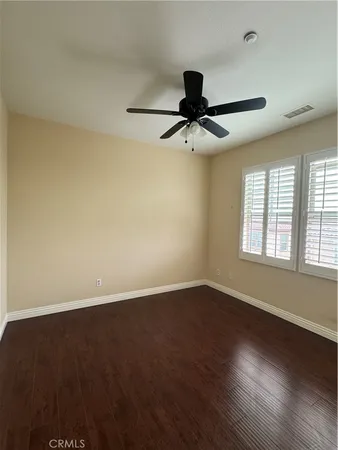 a view of an empty room and wooden floor