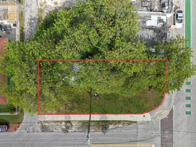 a view of a street with cars parked