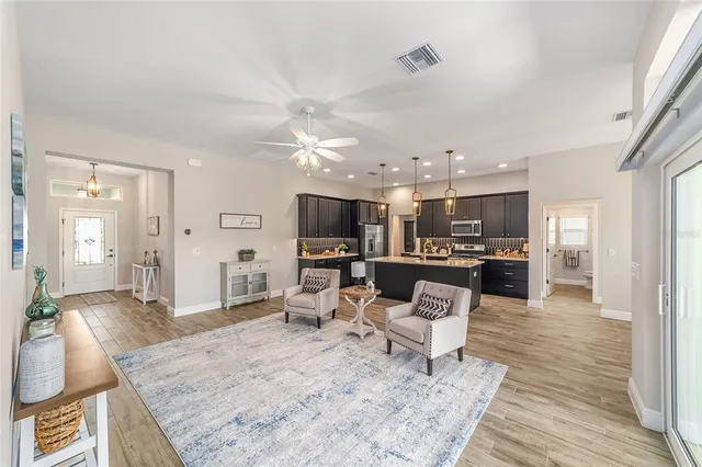 a living room with furniture and kitchen view