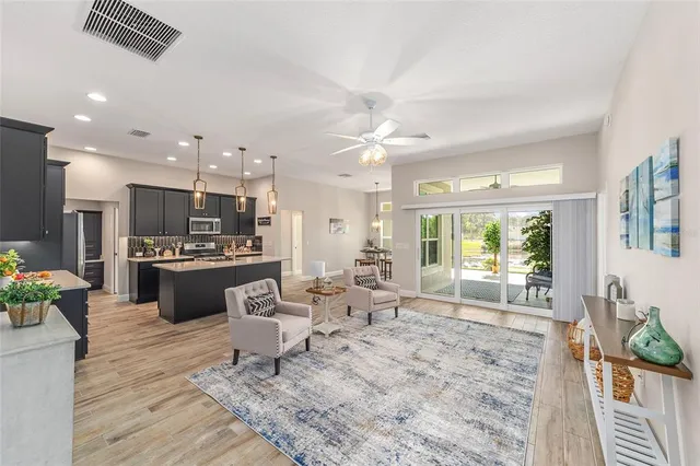 a living room with kitchen island furniture and a large window