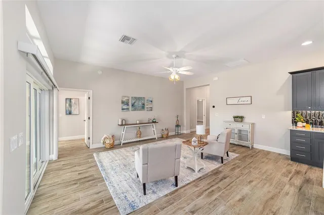 a living room with furniture and a wooden floor