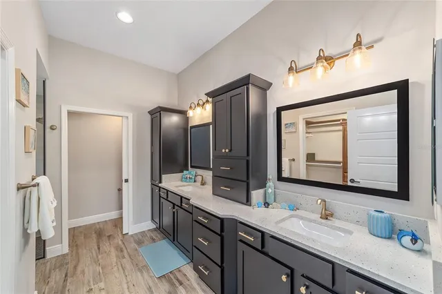 a bathroom with a double vanity sink and mirror