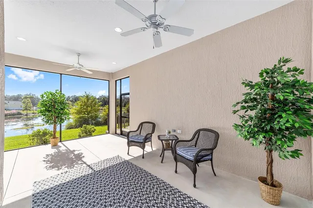 a porch with a bench and a potted plant