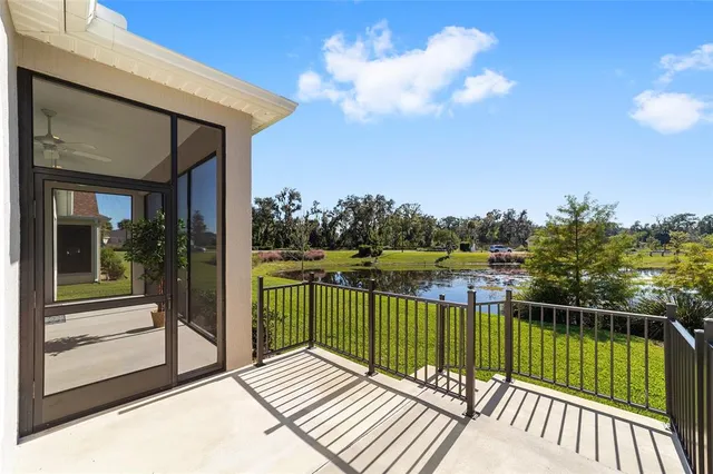 a view of a balcony with lake view and wooden floor