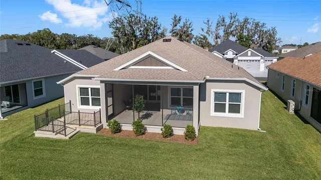 a view of a house with a backyard porch and sitting area