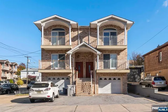 a front view of a house with a parking space