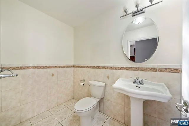 a bathroom with a sink toilet and a mirror