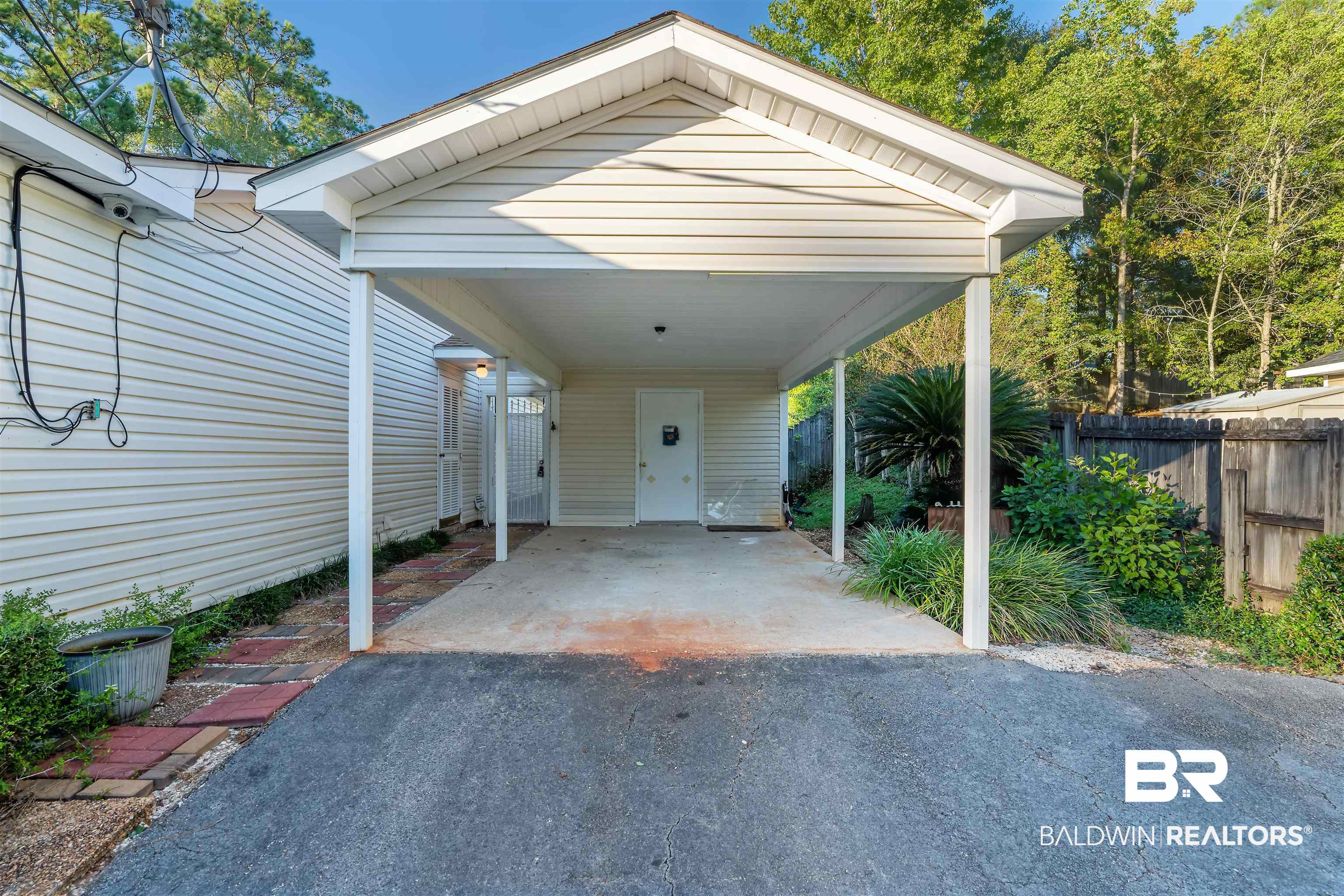 438 Ridgewood Drive Daphne, AL 36526 - Photo 27 of 28 View of parking featuring a carport